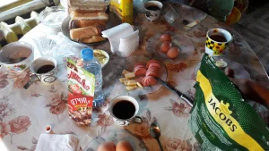 Le petit déjeuner qui est du pain avec de la confiture, un peu de fromage et des oeufs